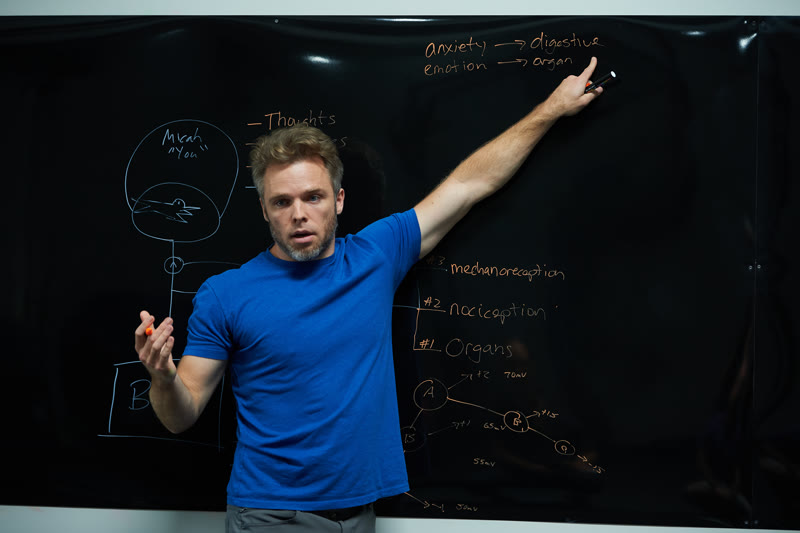 Julian Corwin teaching about pain mechanisms at the blackboard